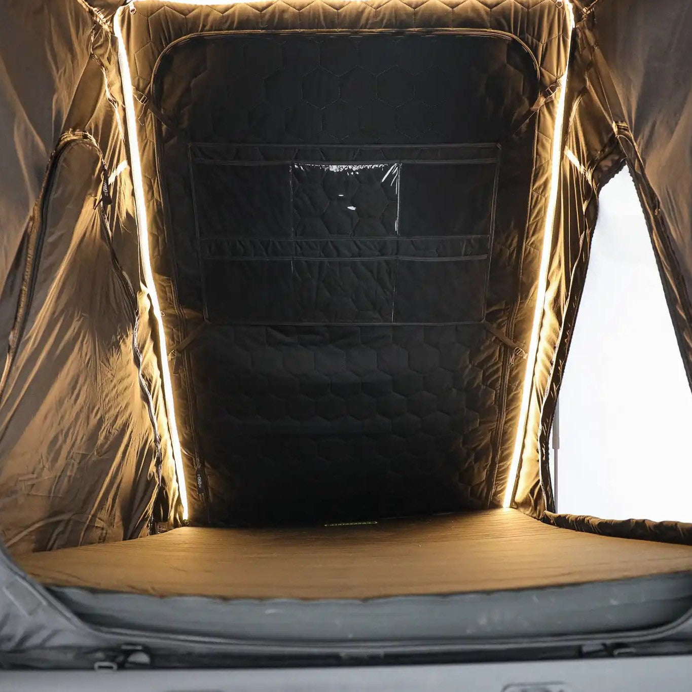Interior photo of the FSR Aspen Lite XL Rooftop Tent with built-in dimmable LED lights illuminated.