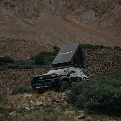 FSR Aspen Pro Rooftop Tent setup on a black Toyota 4Runner in a mountainous campsite at dusk