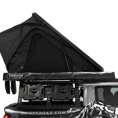 Side profile image of the FSR Aspen Pro rooftop tent from Free Spirit Recreation mounted on the bed a short bed Toyota Tacoma with roof rack