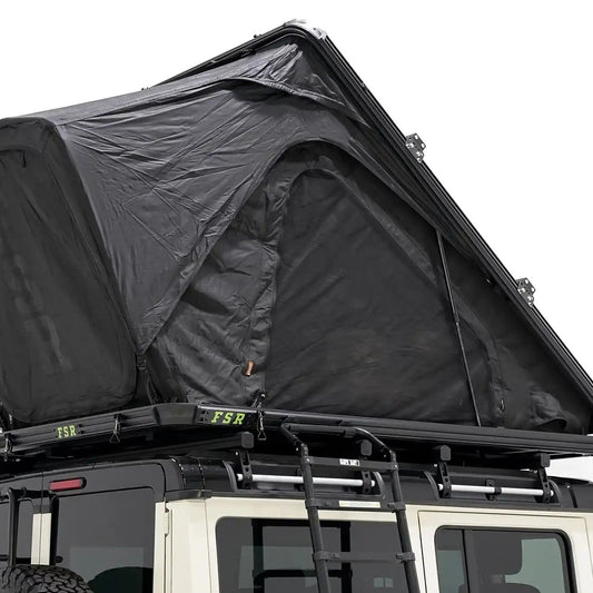 Image of the exterior of the FSR Aspen Pro XL roof top tent from Freespirit Recreation installed and deployed on the roof rack of an Ineos Grenadier