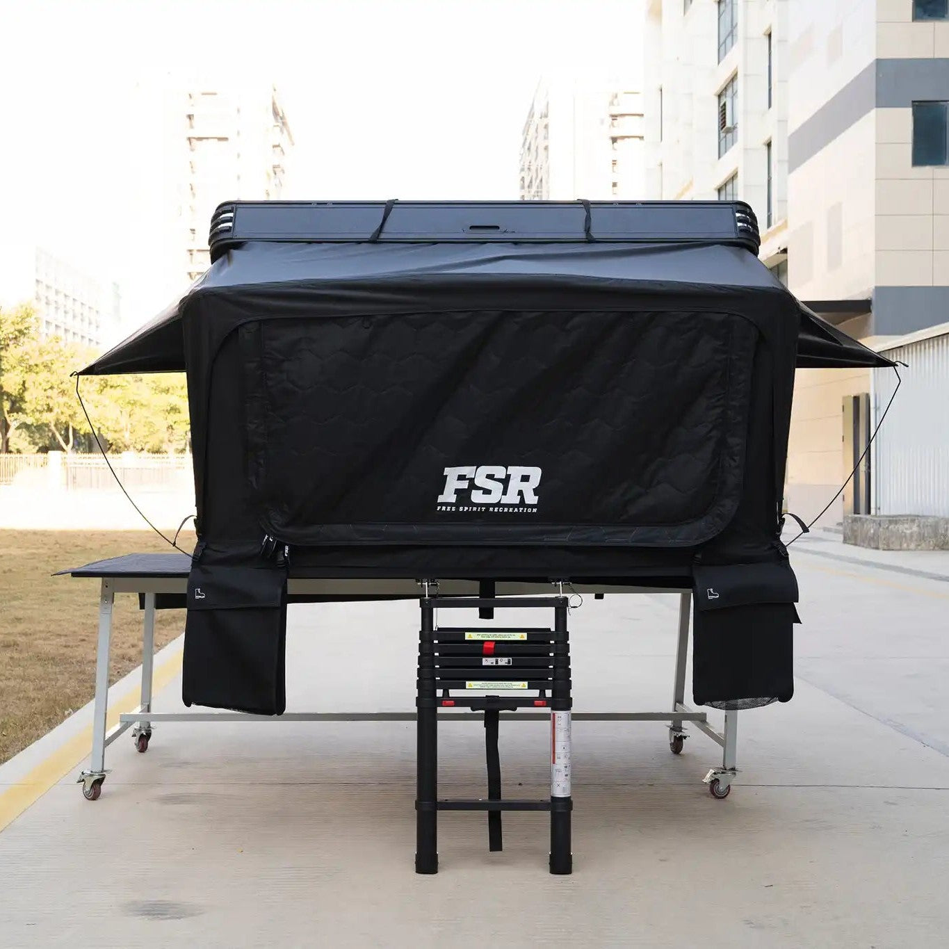 Front-facing Image of the FSR Kali King hard shell rooftop tent from Freespirit Recreation fully deployed with door and windows closed.