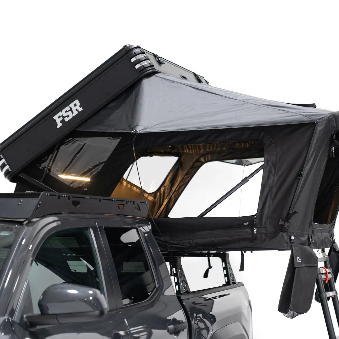 Side-profile exterior photo of Kali hardshell rooftop tent by FSR deployed on a truck bed rack.