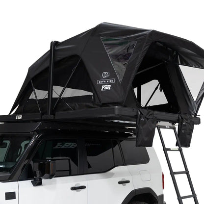 Close-up exterior photo of the Nova King rooftop tent mounted on a white Toyota Land Cruiser with the tent windows and door open.