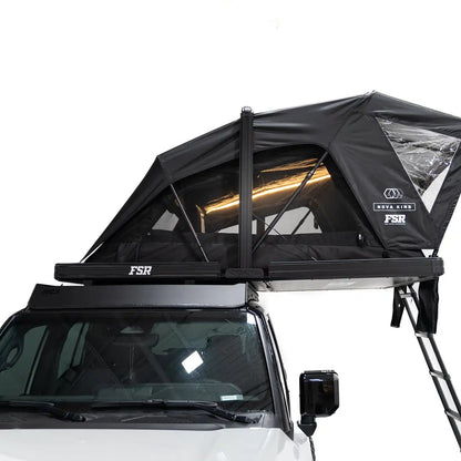 Side-facing exterior photo of the Nova King rooftop tent mounted on a Toyota Land Cruiser with the interior LED tent lights on.