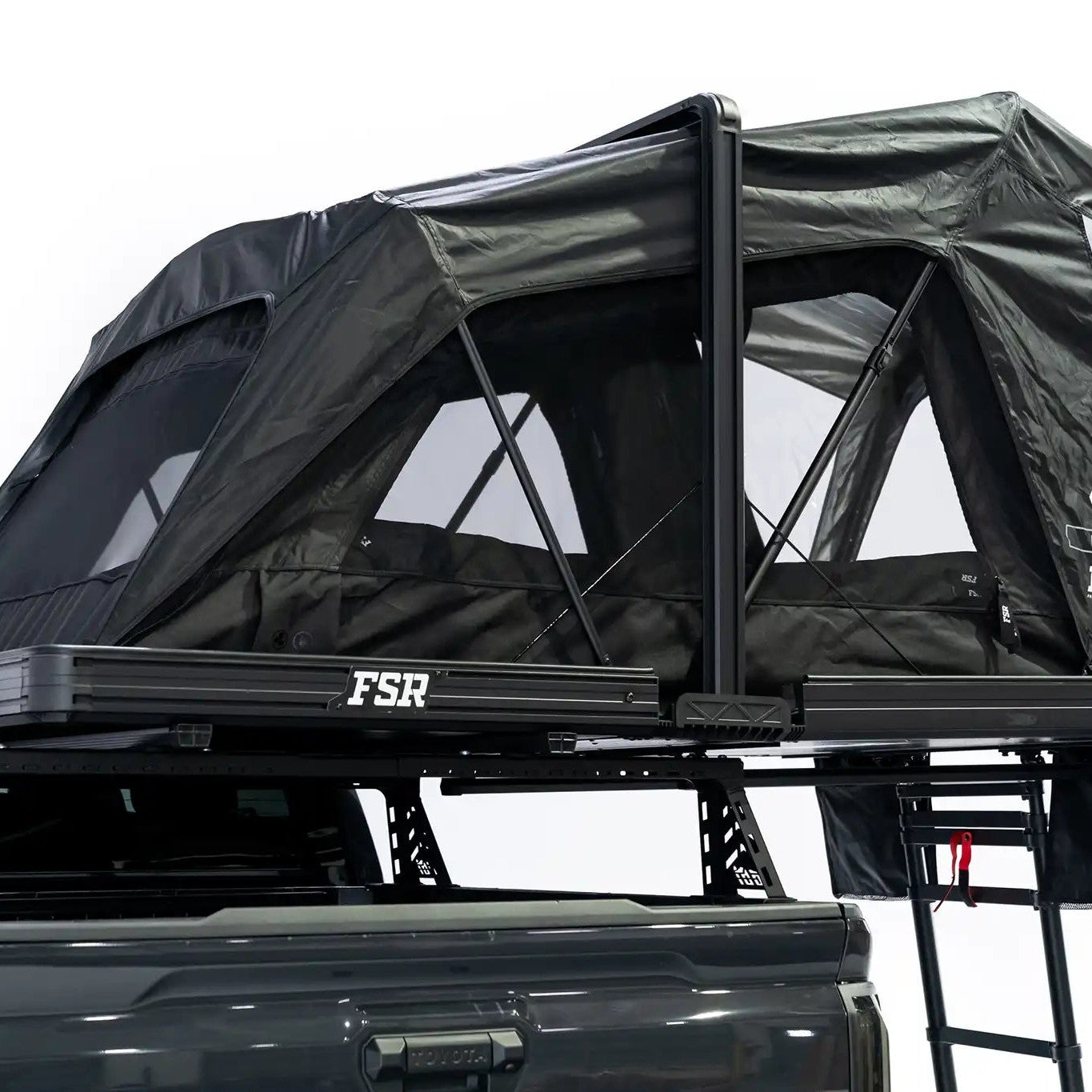 Photo of FSR Nova rooftop tent deployed on the rear of a 2025 Toyota Tacoma with the tent windows and doors open.