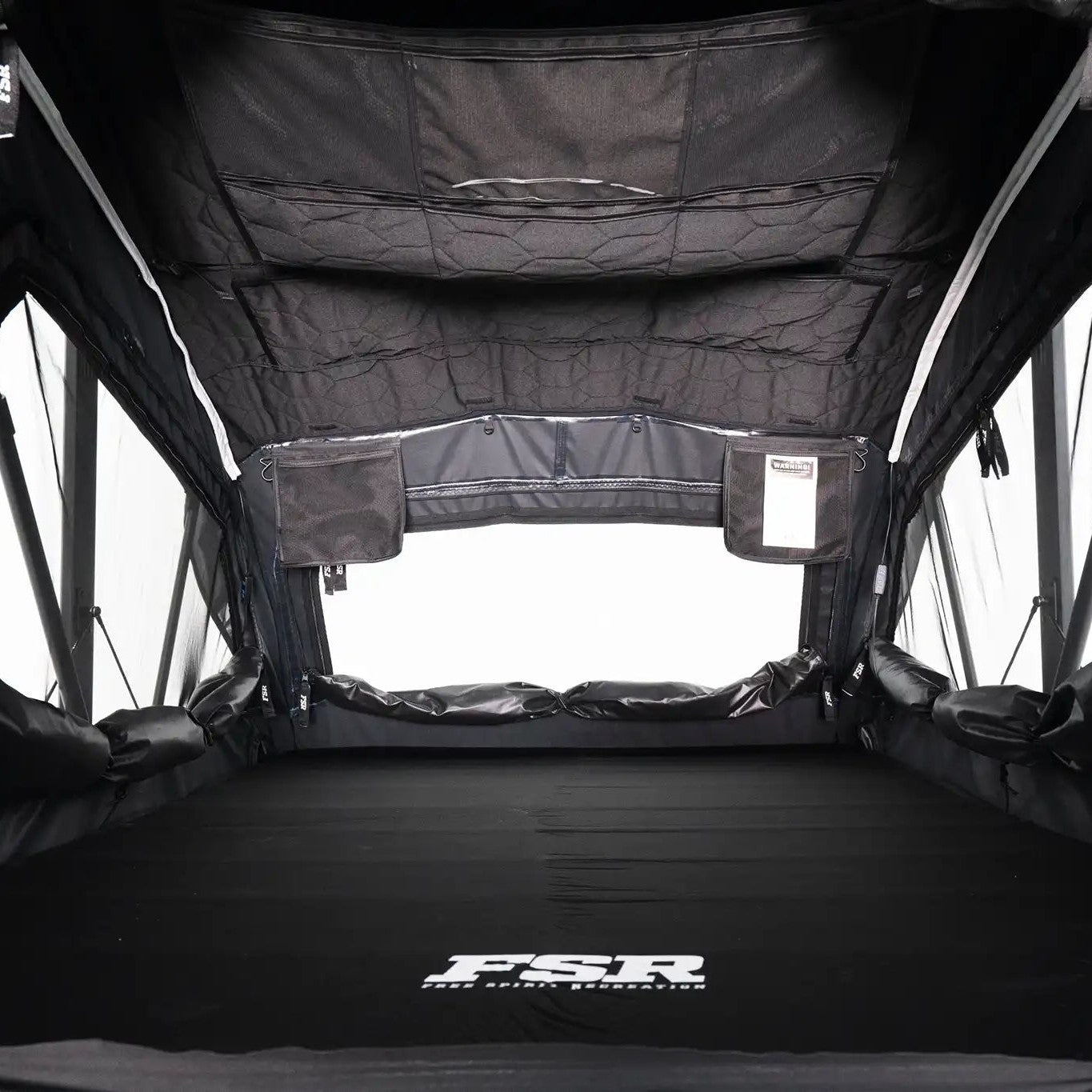 Interior photo of FSR Nova rooftop tent deployed with the interior lights off.