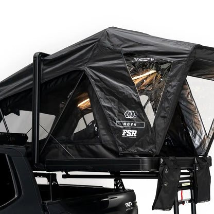 Close up photo of FSR Nova rooftop tent deployed on the rear of a 2025 Toyota Tacoma with the interior LED lights on.