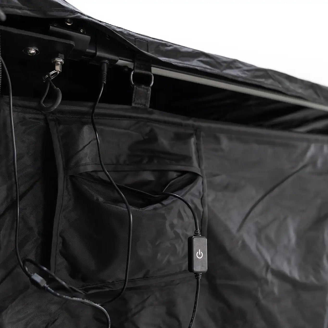 Close up image of the FSR Shower Awning LED light switch and exterior pocket for storing a battery pack