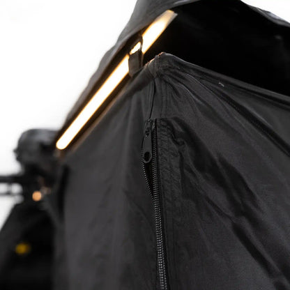 Close up image of the zipper on the FSR Shower Awning with built in LED light illuminated in the background