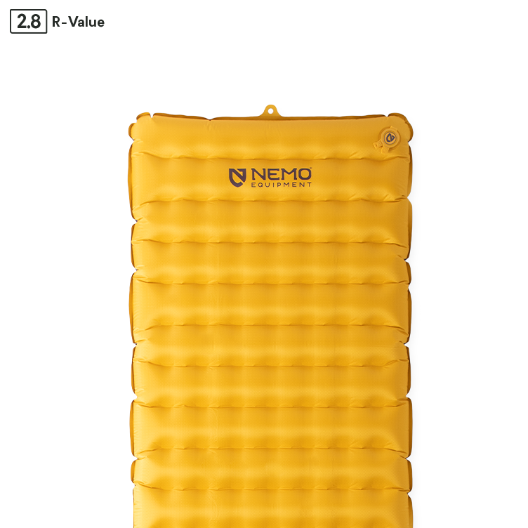 The NEMO Equipment Tensor™ Trail Ultralight Insulated Sleeping Pad is yellow, has horizontal air chambers with Spaceframe baffle design, the NEMO logo, a top right valve, and an R-value of 2.8.