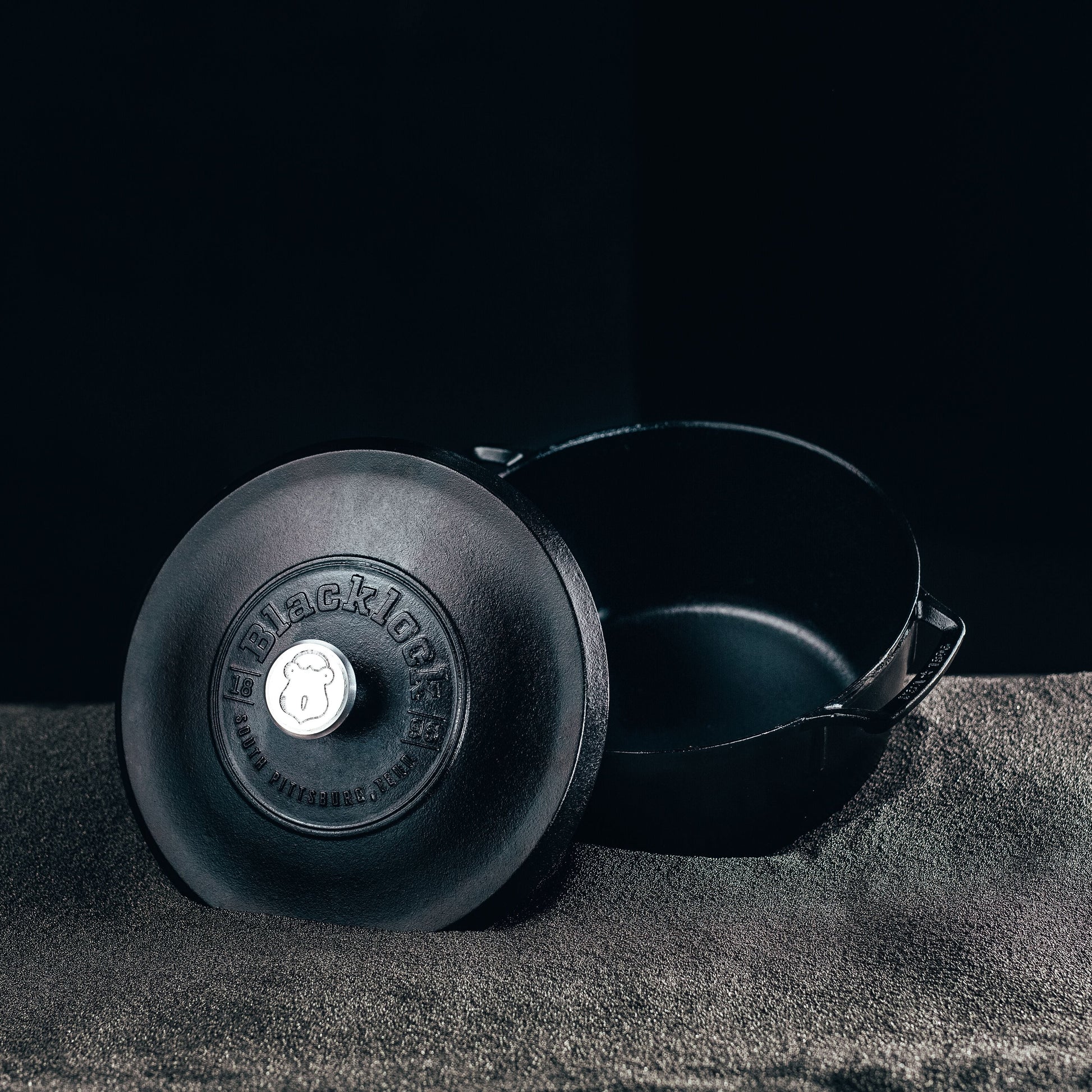 Dutch oven displayed on black background.