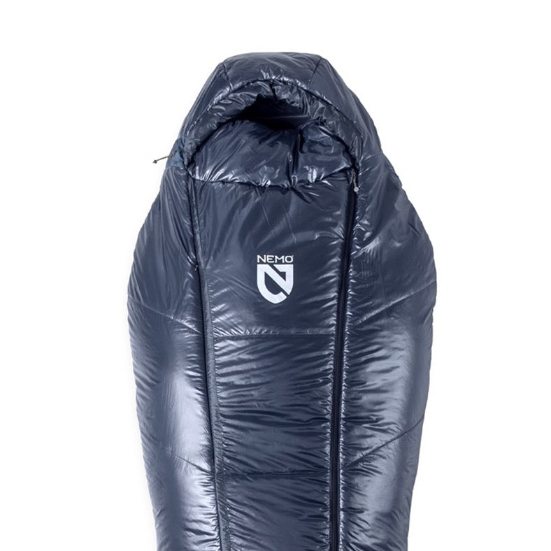 The NEMO Equipment Soul™ Endless Promise® Synthetic Mummy Sleeping Bag is dark blue with a hood, features the NEMO logo on the front, and is filled with recycled synthetic insulation for eco-friendly warmth.
