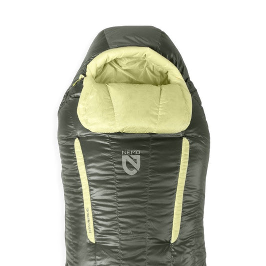 A NEMO Equipment Disco™ Women's Endless Promise® Down Sleeping Bag in green and yellow, featuring a hood and built-in pillow section, is displayed against a white background.
