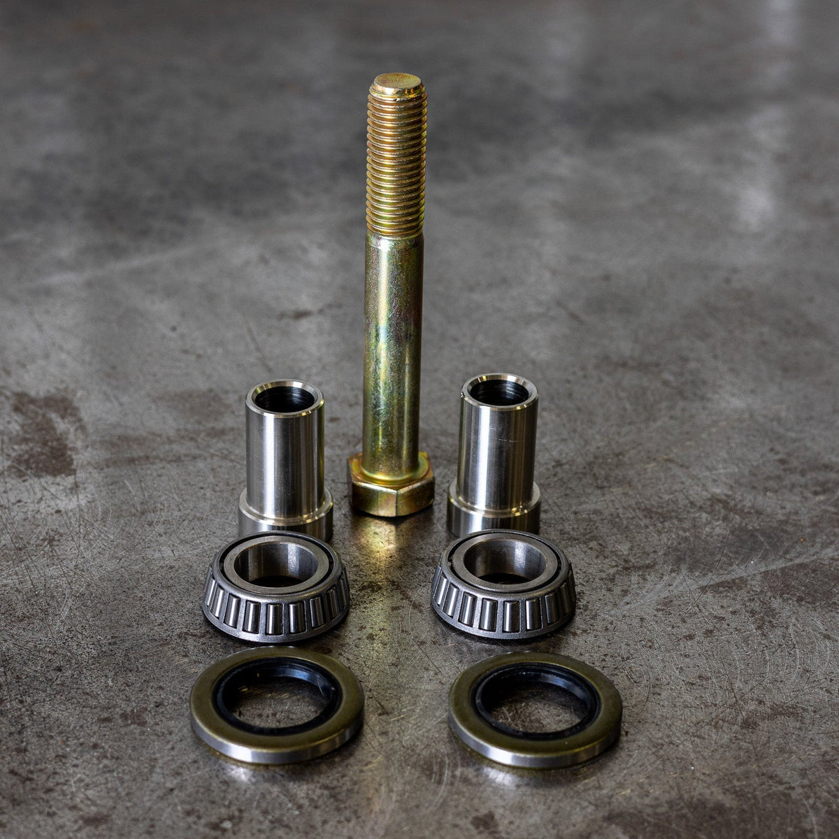 Close up view of all the components of the C4 swing arm bearing rebuild kit.