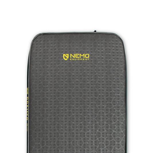 Close-up of a gray NEMO Equipment Roamer™ Self-Inflating Mattress featuring a textured hexagonal pattern and yellow logo near the top center.